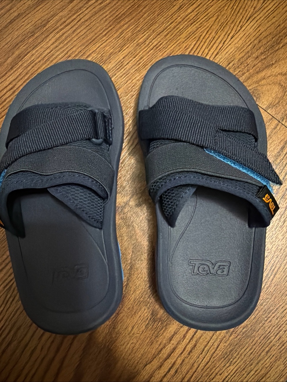 Teva Black Slide Sandals with Blue Accent